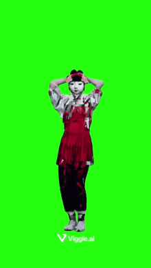 a woman in a red dress is standing on a green screen with her hands behind her head .