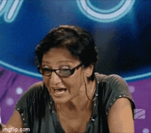 a woman wearing glasses is making a funny face in front of a sign that says ' imgflip.com '