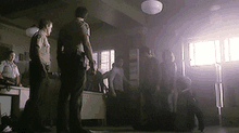 a group of police officers are standing in a room