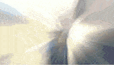 a blurred image of a person 's butt with the sun shining through