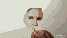 a drawing of a man 's face is being made by made in animatica