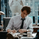 a man sits at a desk with a clock and a cup that says ' twenty dollars ' on it