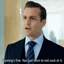 a man in a suit and tie is saying " gloating 's fine you just have to not suck at it "