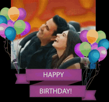 a man and a woman are sitting on a roller coaster with balloons behind them and a banner that says happy birthday
