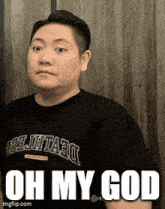 a man wearing a black shirt that says devils on it