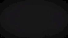 a red and yellow circle with a hole in the middle on a black background