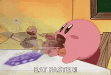 kirby is sitting at a table with his mouth open and eating a piece of food .