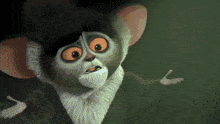 a close up of a cartoon monkey with big orange eyes and a beard