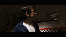 a man in a blue jacket says " and i 'm surviving five nights " in a dark room