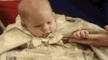 a baby with a pacifier in its mouth is being held by a person