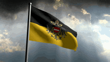 a black and yellow flag with a coat of arms on it is flying in the wind