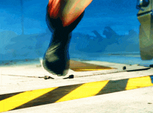 a close up of a person 's foot on a yellow and black striped floor