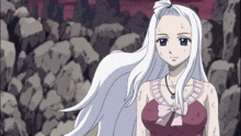 a girl with white hair and blue eyes stands in a rocky area