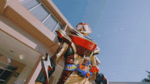 a robot is standing in front of a building with a sign that says ' exit ' on it