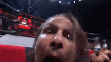 a man in a wrestling ring making a funny face