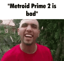 a man in a red shirt is making a funny face with the words " metroid prime 2 is bad " above him .