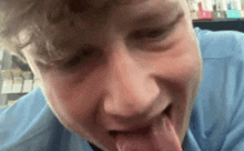 a close up of a man with his tongue out