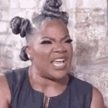 oprah winfrey is making a funny face while wearing a black dress .