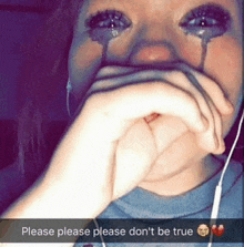 a girl with tears coming out of her eyes covering her mouth with her hand