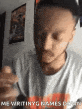 a man with a beard is holding a pen in his hand and making a funny face .