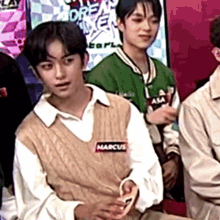 a man wearing a vest with the name marcus on it