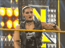 a woman in a wrestling ring with the letter n on the back of her shirt