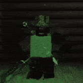 a video game character is glowing in the dark and has the letter t on his hat