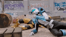 a man in a superhero suit is laying on the ground