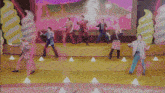 a group of people are dancing on a stage
