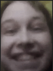 a blurry picture of a woman 's face with her eyes closed and her mouth open