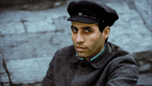 a man wearing a black hat with a letter r on it