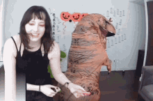 a woman in a t-rex costume stands next to another woman
