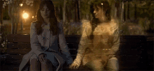 a woman is sitting on a bench with a ghost in the background .