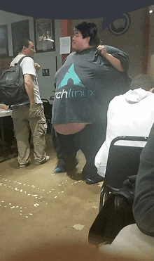 a man wearing a t-shirt that says ' chlinux ' on it
