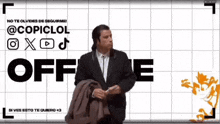 a man in a suit is standing in front of a sign that says off me
