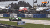 a race car on a track with a mobil 1 sign