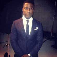 a man in a suit and tie has a pocket square on his left pocket