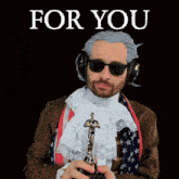a man in a wig and sunglasses holds an oscar statue in front of a sign that says for you