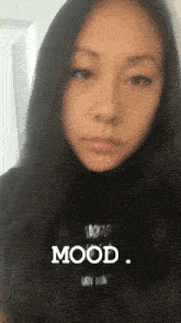 a close up of a woman 's face with the words mood written in white