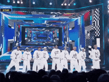 a group of dancers on a stage with a sign that says comeback & team on it