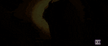 a silhouette of a man with hk written on the bottom