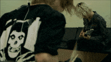 a person wearing a shirt with a skull and crossbones on it