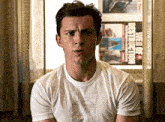 a man wearing a white t-shirt with a picture of a bottle of milk on it