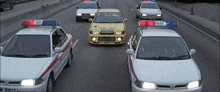 a row of police cars are driving down a road