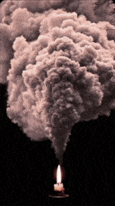 smoke coming out of a candle with a black background