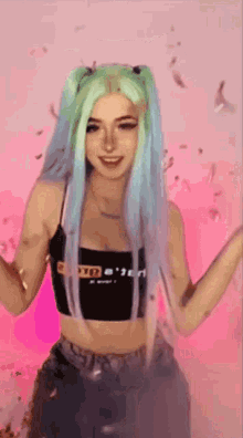 a woman with blue hair is wearing a black crop top that says pornhub on it