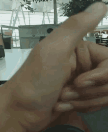 a close up of a person 's hand with their thumb up