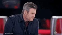 a man sitting in a chair with a nbc logo on the bottom