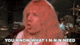 a man singing into a microphone with the words " you know what i n-n-n-need " next to him