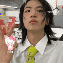 a person wearing a hello kitty shirt and tie